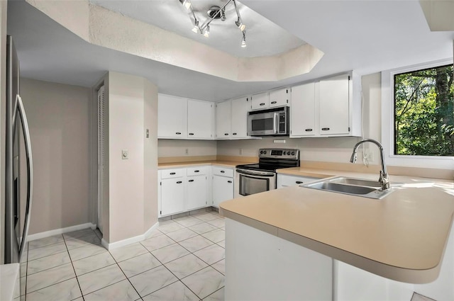 kitchen featuring white cabinets, light tile patterned floors, stainless steel appliances, and sink