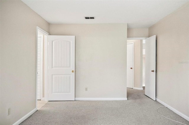 unfurnished bedroom featuring light carpet