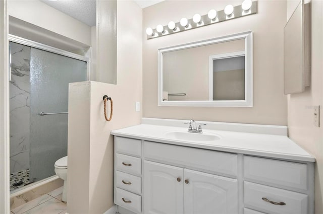 bathroom featuring toilet, vanity, a textured ceiling, and walk in shower