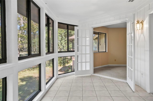 unfurnished sunroom with plenty of natural light and french doors