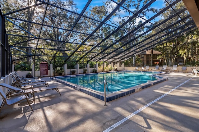 view of swimming pool with a lanai and a patio area