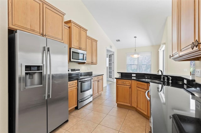 kitchen with stainless steel appliances, sink, light tile patterned floors, lofted ceiling, and pendant lighting