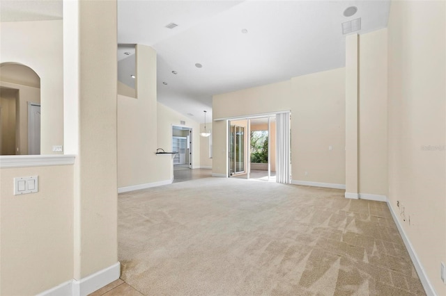 carpeted spare room featuring lofted ceiling