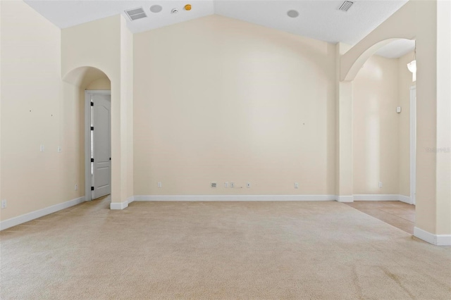 carpeted spare room with lofted ceiling