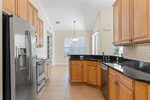 kitchen featuring appliances with stainless steel finishes, decorative light fixtures, light tile patterned floors, sink, and vaulted ceiling