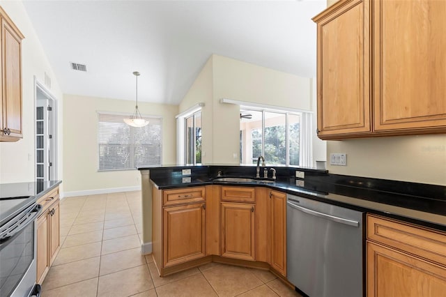 kitchen featuring light tile patterned flooring, stainless steel appliances, dark stone counters, pendant lighting, and sink