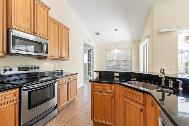 kitchen featuring stainless steel appliances, sink, light tile patterned floors, hanging light fixtures, and vaulted ceiling