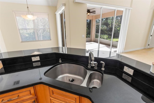 interior details featuring sink, decorative light fixtures, and ceiling fan