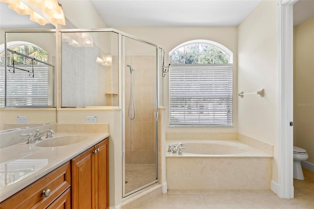 full bathroom with tile patterned flooring, shower with separate bathtub, a healthy amount of sunlight, and vanity