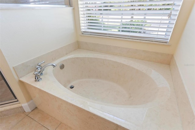 bathroom featuring tiled bath and tile patterned floors