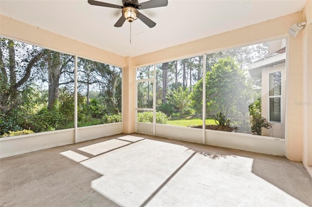 unfurnished sunroom featuring ceiling fan