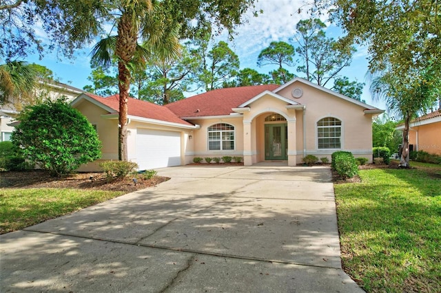 view of front of home with a garage and a front yard