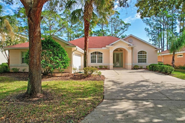 view of front of house with a garage and a front yard