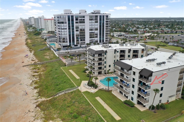 birds eye view of property featuring a water view and a view of the beach