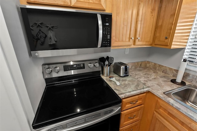 kitchen featuring stainless steel appliances and sink