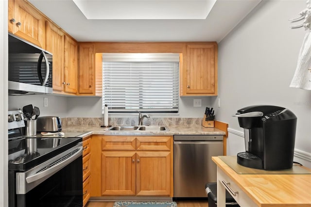 kitchen with sink and appliances with stainless steel finishes