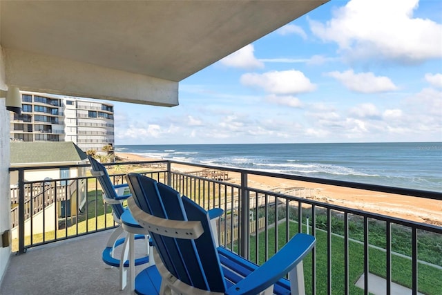 balcony featuring a beach view and a water view