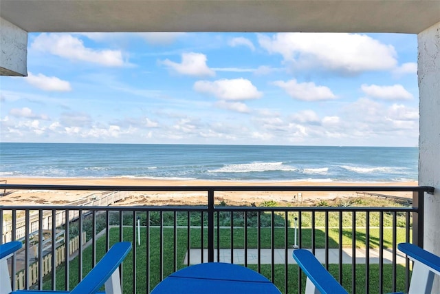 balcony with a water view and a beach view