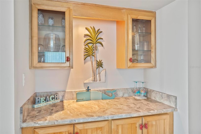 bar featuring light brown cabinets