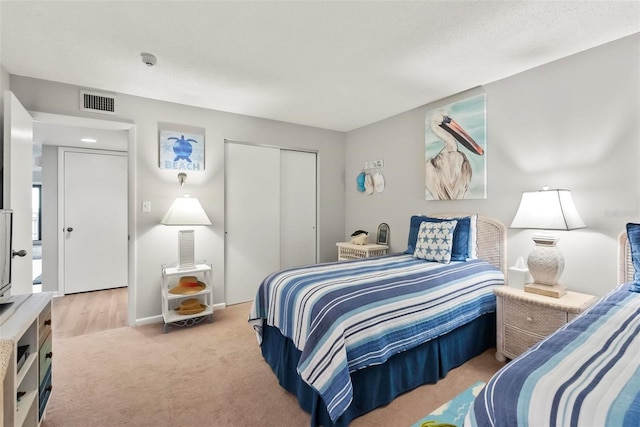 carpeted bedroom with a closet