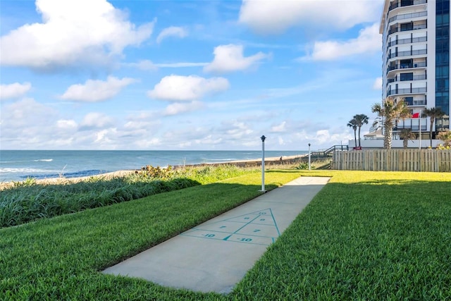 view of property's community featuring a yard and a water view