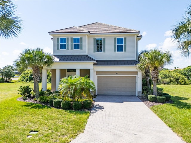 view of front of property featuring a garage and a front yard