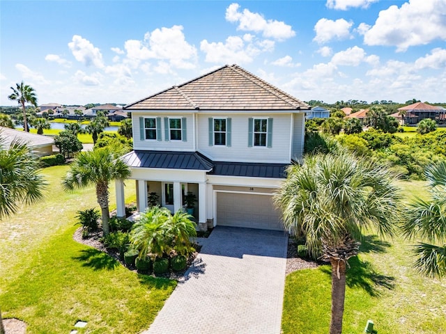 view of front of house with a garage and a front yard