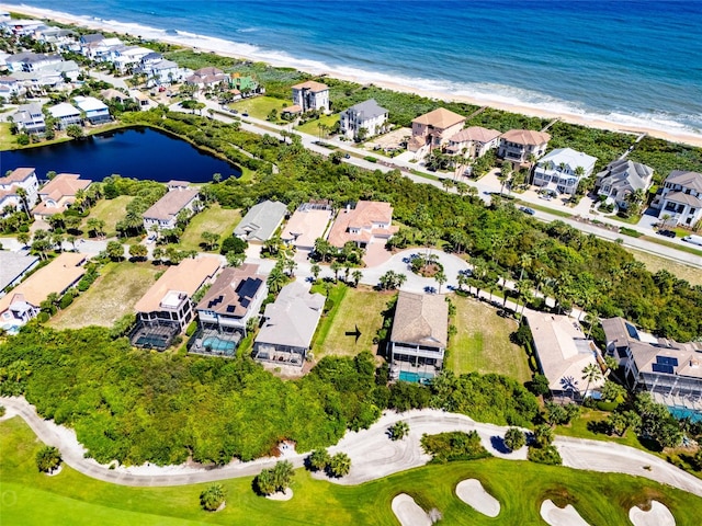 birds eye view of property with a beach view and a water view