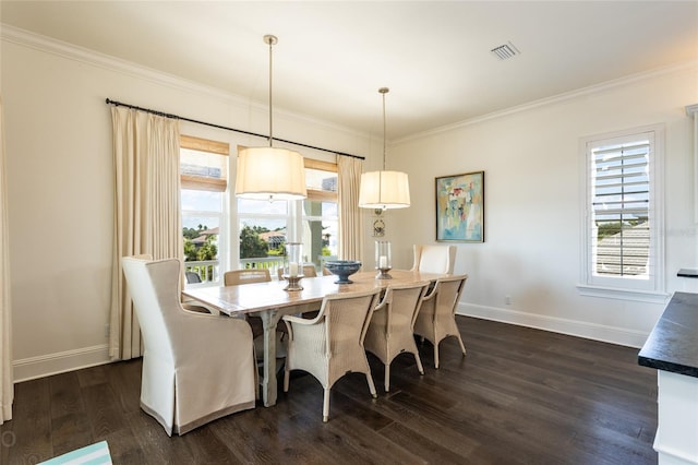 dining room with crown molding, a healthy amount of sunlight, and dark hardwood / wood-style floors