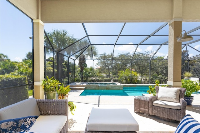 view of pool featuring a lanai, an outdoor hangout area, an in ground hot tub, and a patio