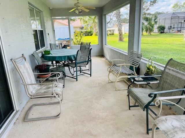 sunroom / solarium with ceiling fan and a healthy amount of sunlight