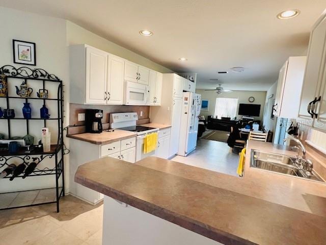 kitchen with white cabinetry, sink, ceiling fan, and white appliances