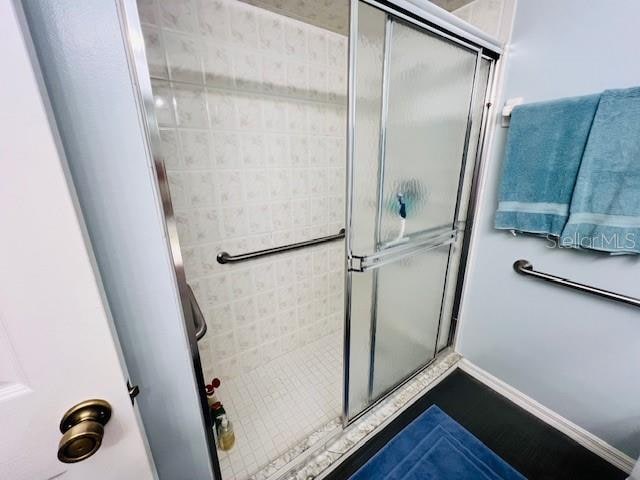 bathroom with a shower with door