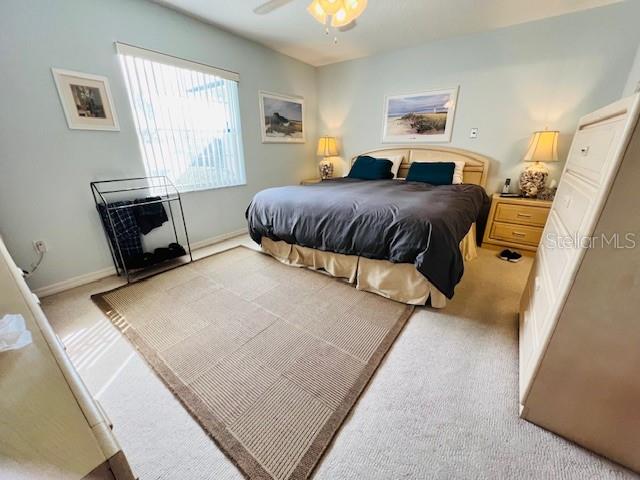 carpeted bedroom featuring ceiling fan