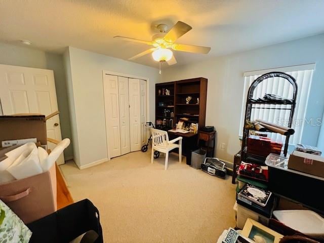 office featuring light carpet and ceiling fan