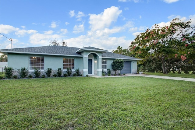 ranch-style home featuring a front lawn and a garage