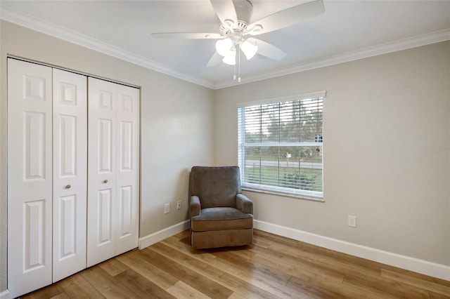 living area with wood-type flooring, ceiling fan, and crown molding