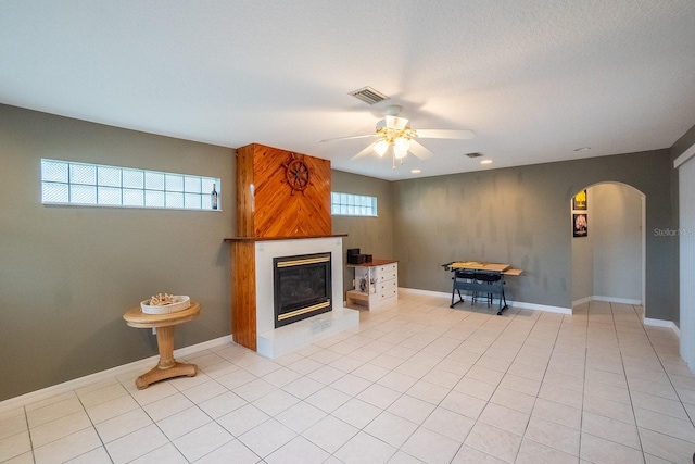 unfurnished living room featuring ceiling fan and light tile patterned flooring