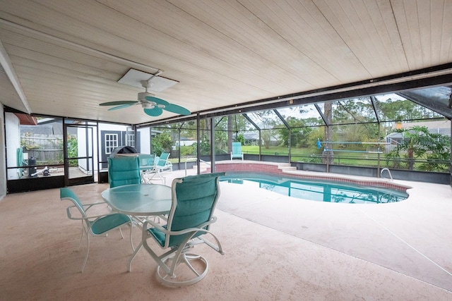 view of pool with ceiling fan, a patio area, and a lanai