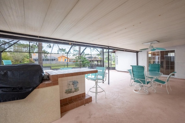 sunroom with ceiling fan and a healthy amount of sunlight