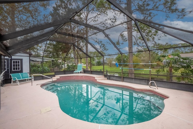 view of pool featuring glass enclosure and a patio area