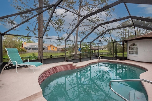 view of pool with a patio and glass enclosure