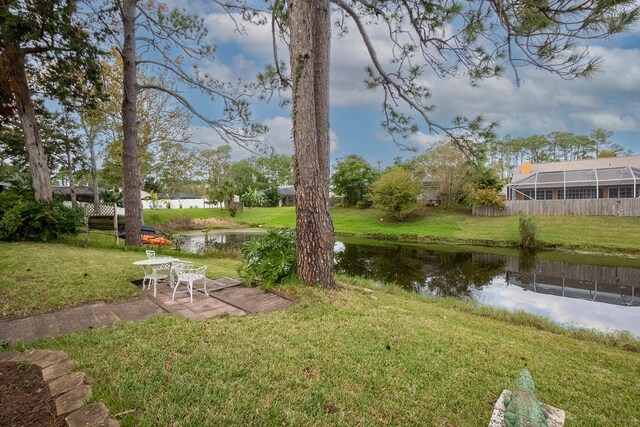 view of yard with a water view and a patio