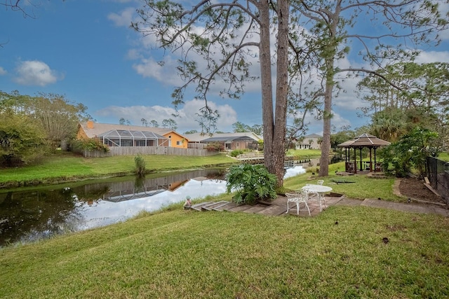 view of yard featuring a gazebo and a water view