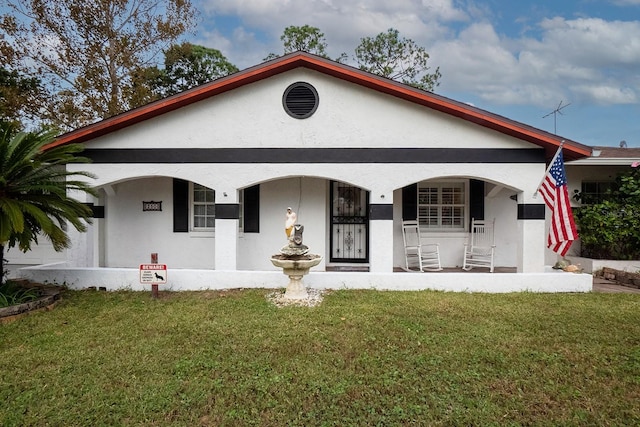 view of front of property with covered porch and a front yard