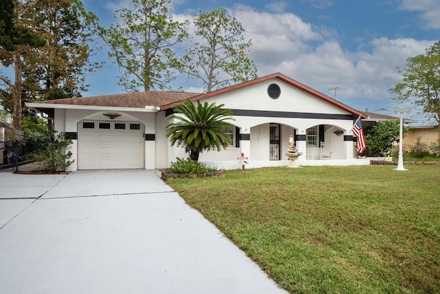 view of front of property featuring a garage and a front lawn