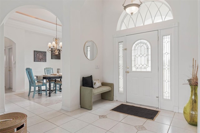 tiled entryway featuring a chandelier