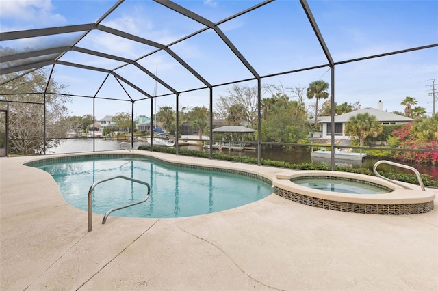 view of swimming pool with a lanai, a patio area, an in ground hot tub, and a water view