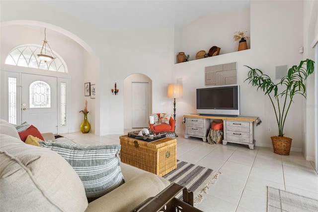 tiled living room with high vaulted ceiling