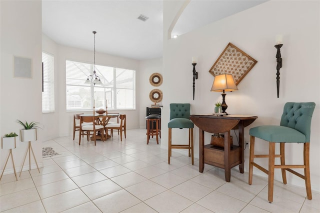 interior space with a notable chandelier and light tile patterned flooring